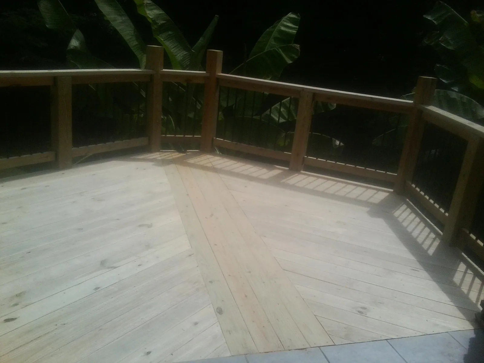 New wood deck and railing built off the back of a home in Freeport